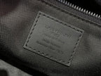 Louis Vuitton interior leather label on dark fabric, stitched text panel