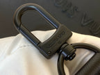Louis Vuitton bag hardware with dark metal D-ring and clip