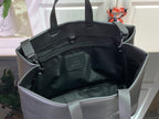 Open tote bag interior with zippered pocket and dark lining, leather handles