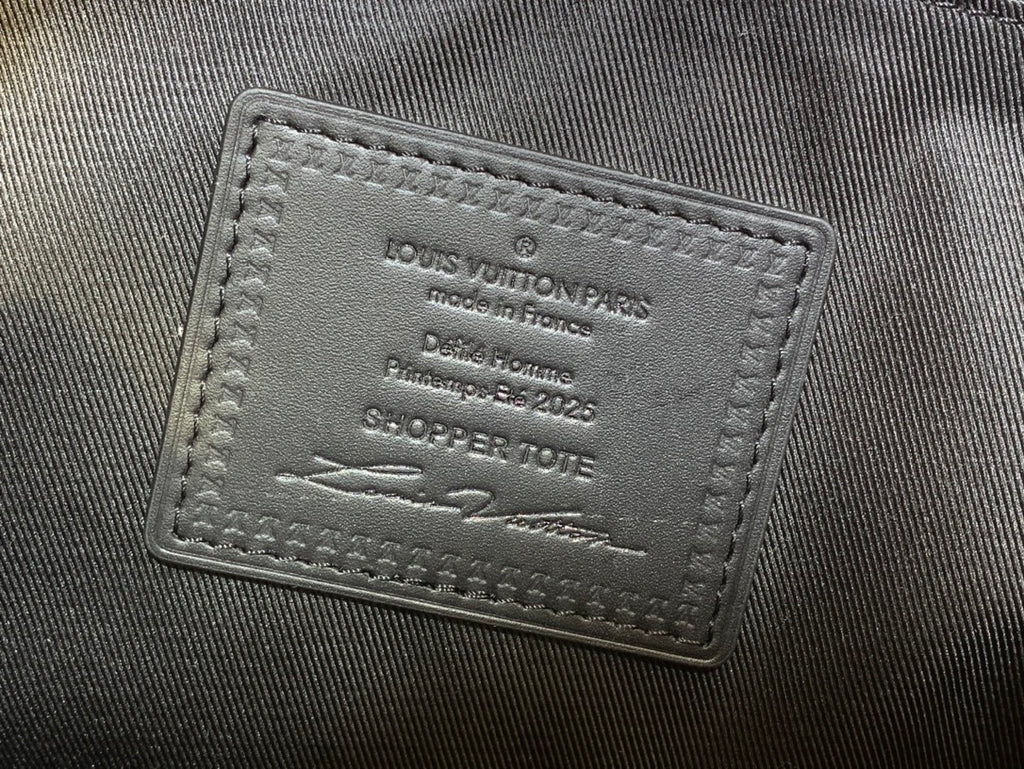 Leather brand tag on tote bag showing Louis Vuitton Paris and production details