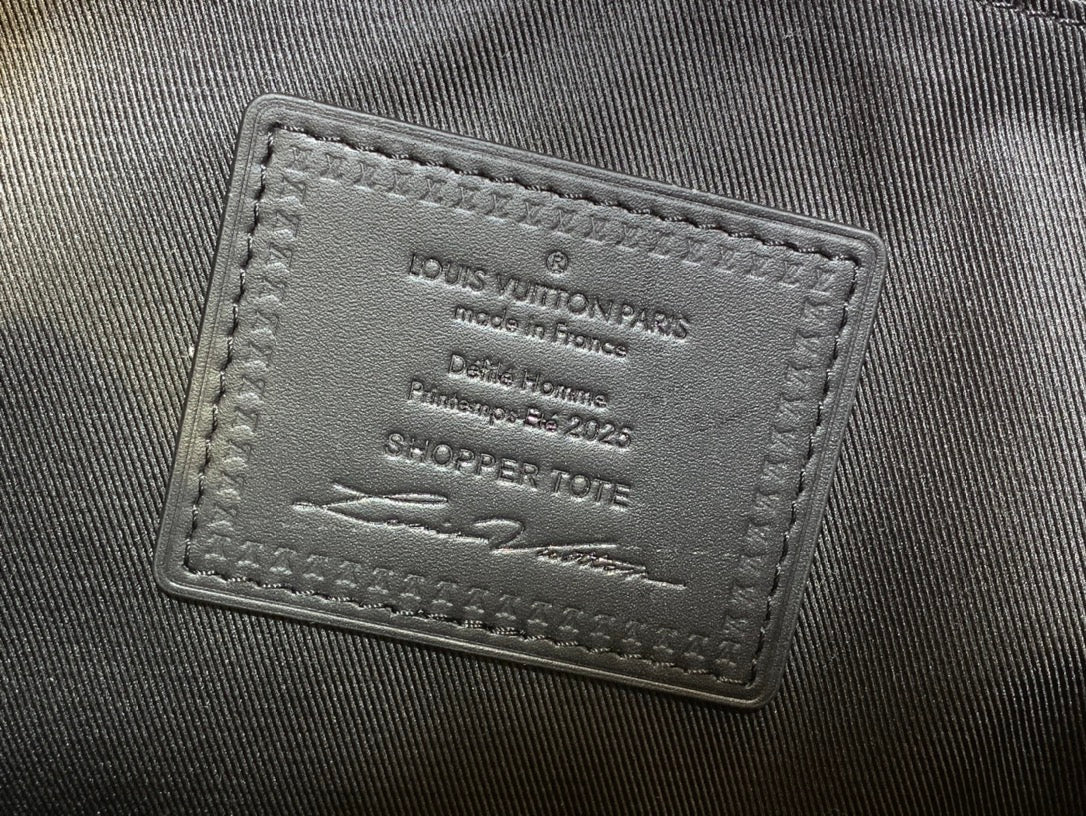 Leather brand tag on tote bag showing Louis Vuitton Paris and production details