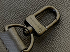 Close-up of snap hook on textured strap with embossed logo