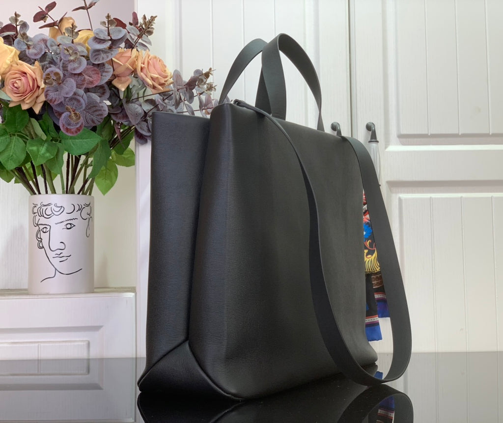Tote bag with curved handles and wide front opening, dark gray leather exterior