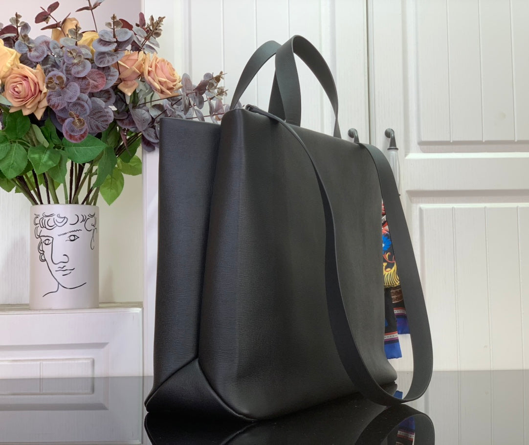 Tote bag with curved handles and wide front opening, dark gray leather exterior