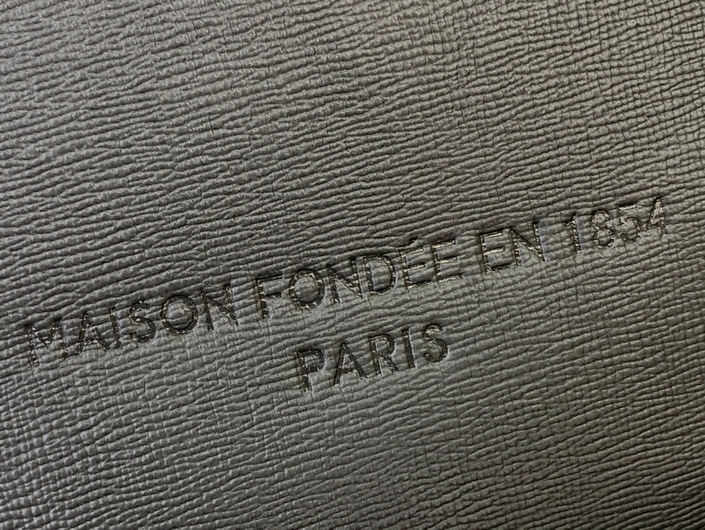 Embossed Louis Vuitton logo on textured leather patch