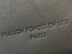 Embossed Louis Vuitton logo on textured leather patch