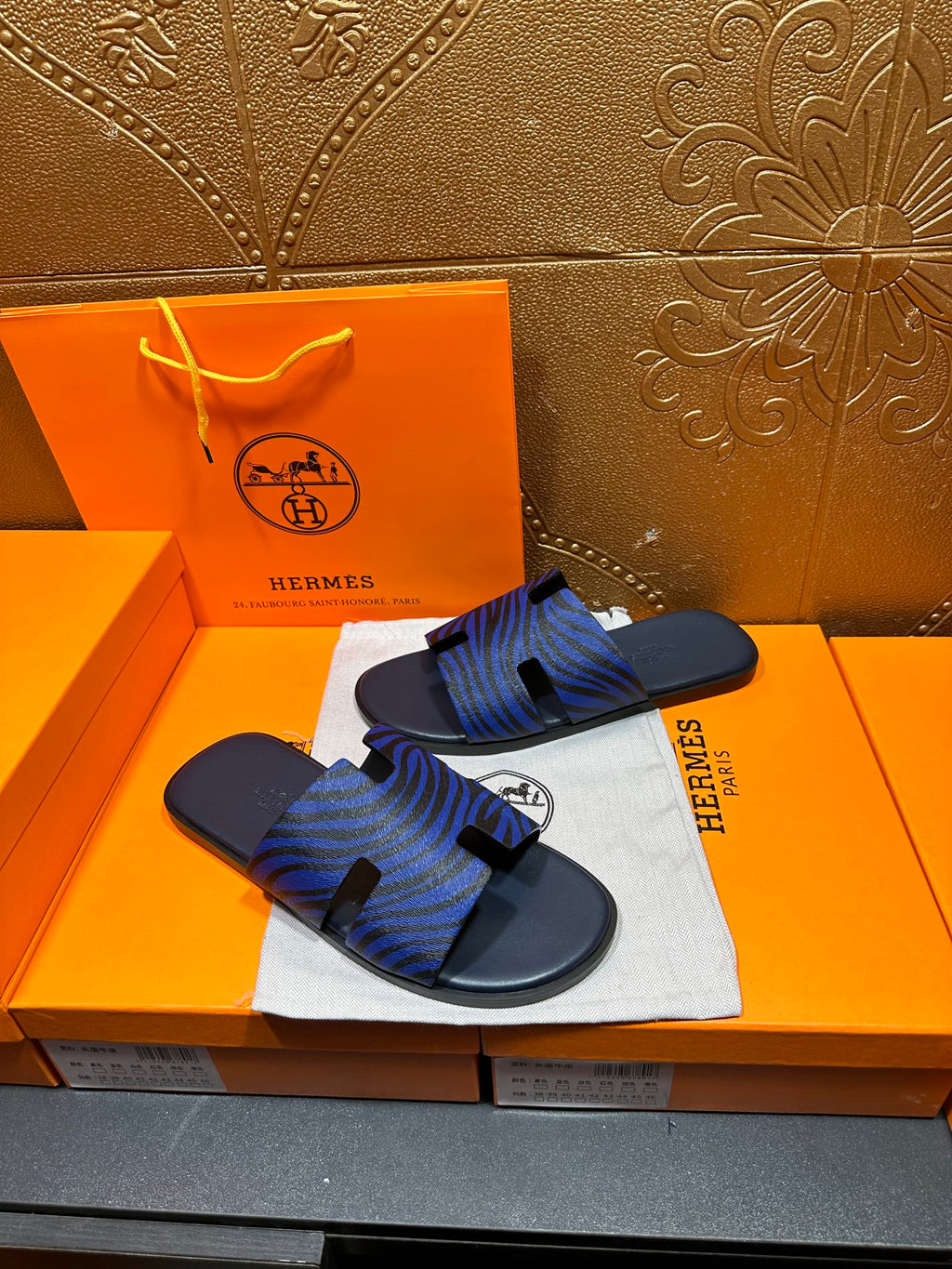 Blue patterned slide sandals with dark base and black strap