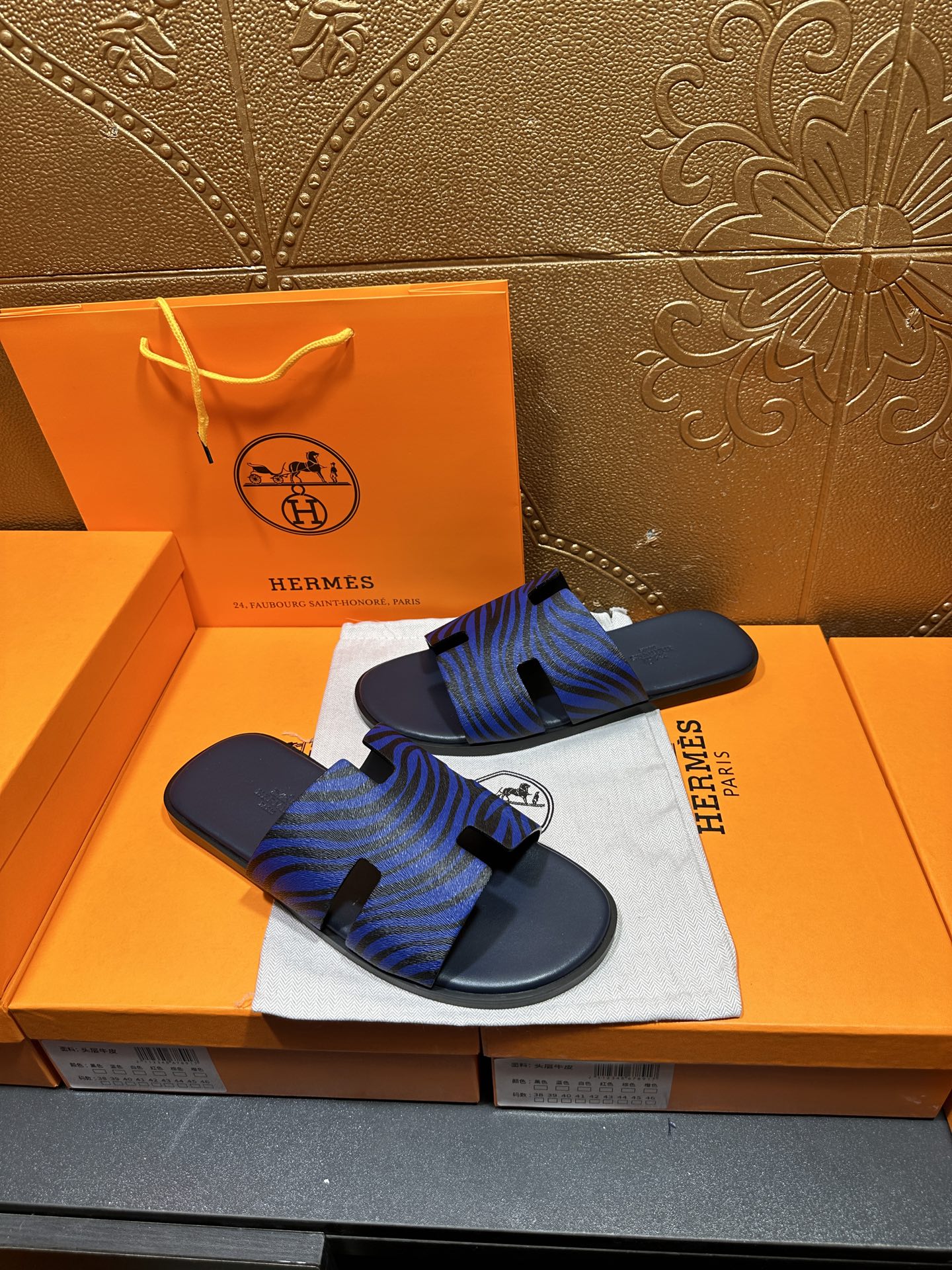 Blue patterned slide sandals with dark base and black strap