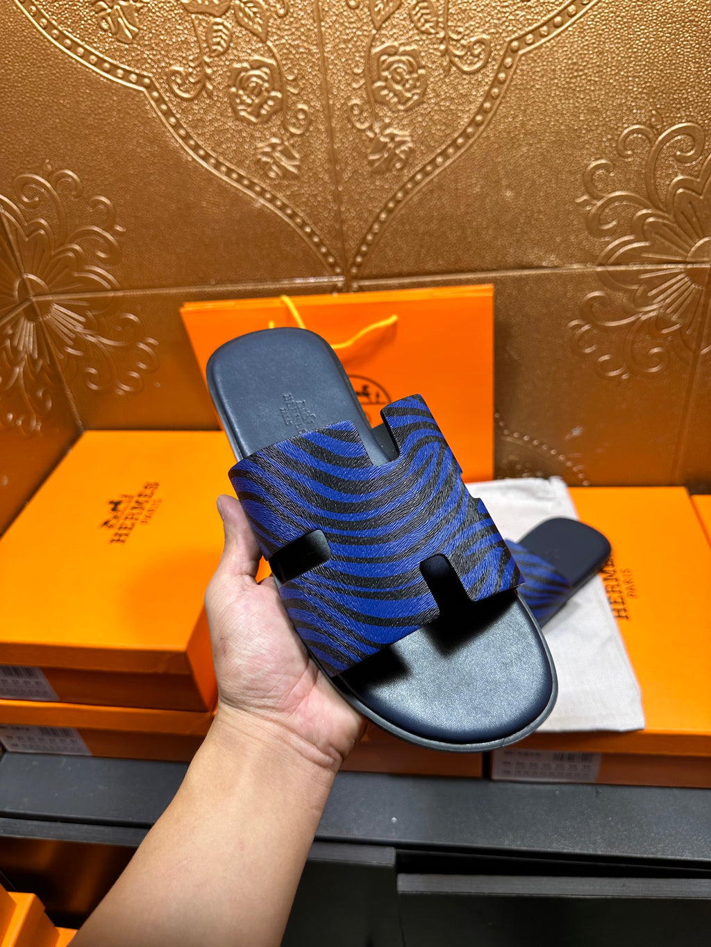 Blue patterned slide sandals side view with black strap