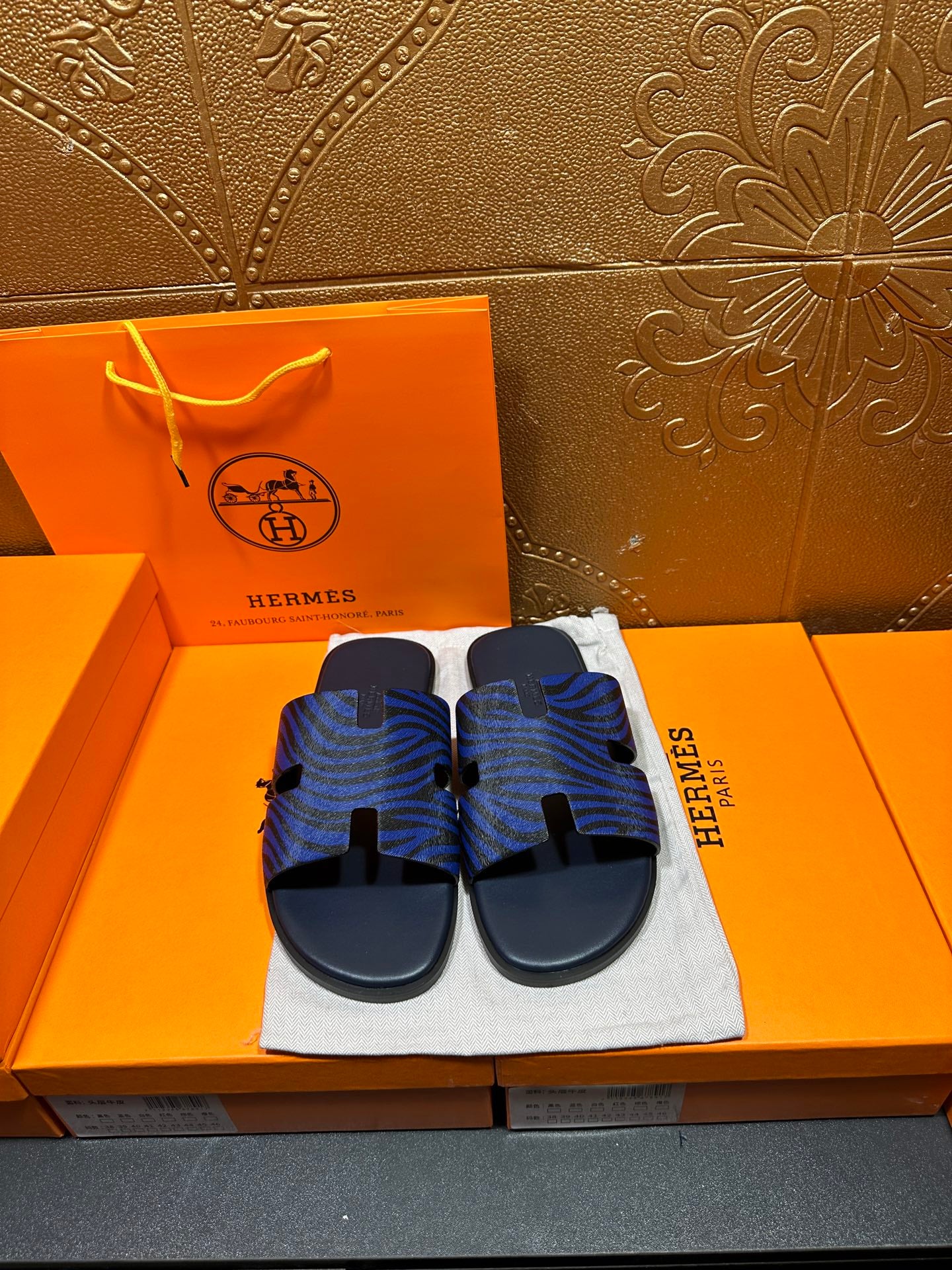Blue patterned slide sandals with black adjustable strap