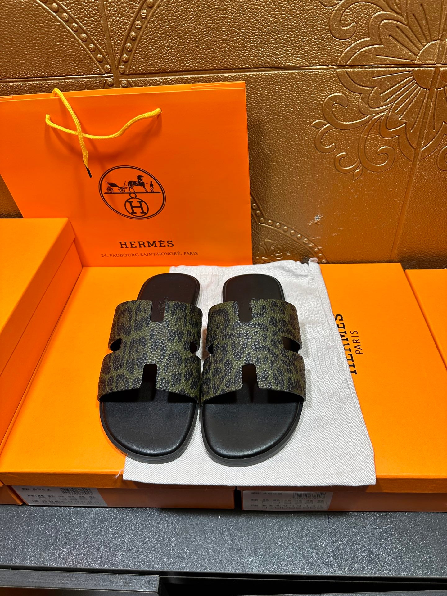Hermes luxury slide sandals, dark patterned straps with black footbeds