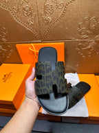 Hermes luxury slide sandals, dark patterned single strap with cutout detail