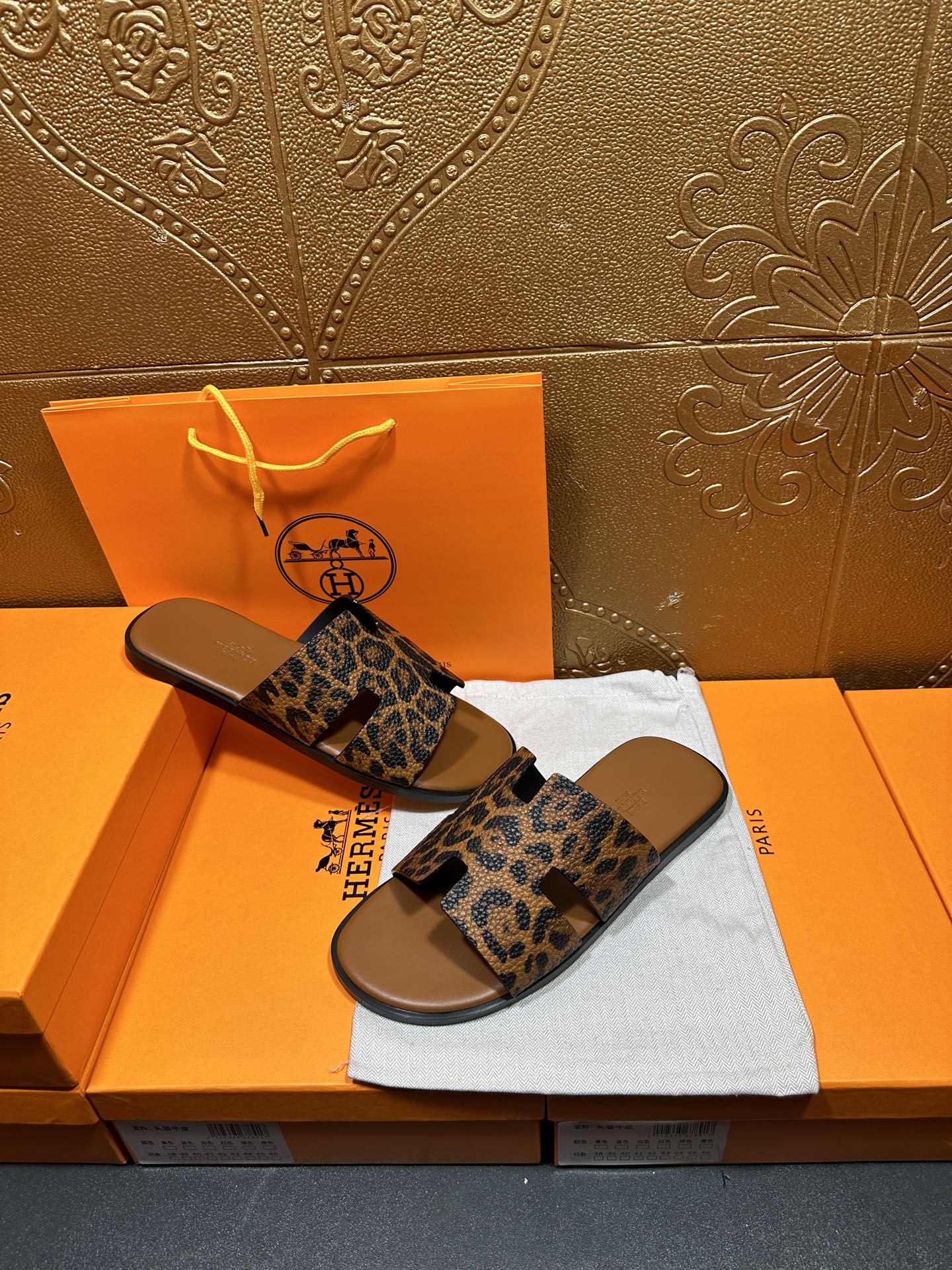 Hermes leopard-print slide sandals with tan footbed and wide straps