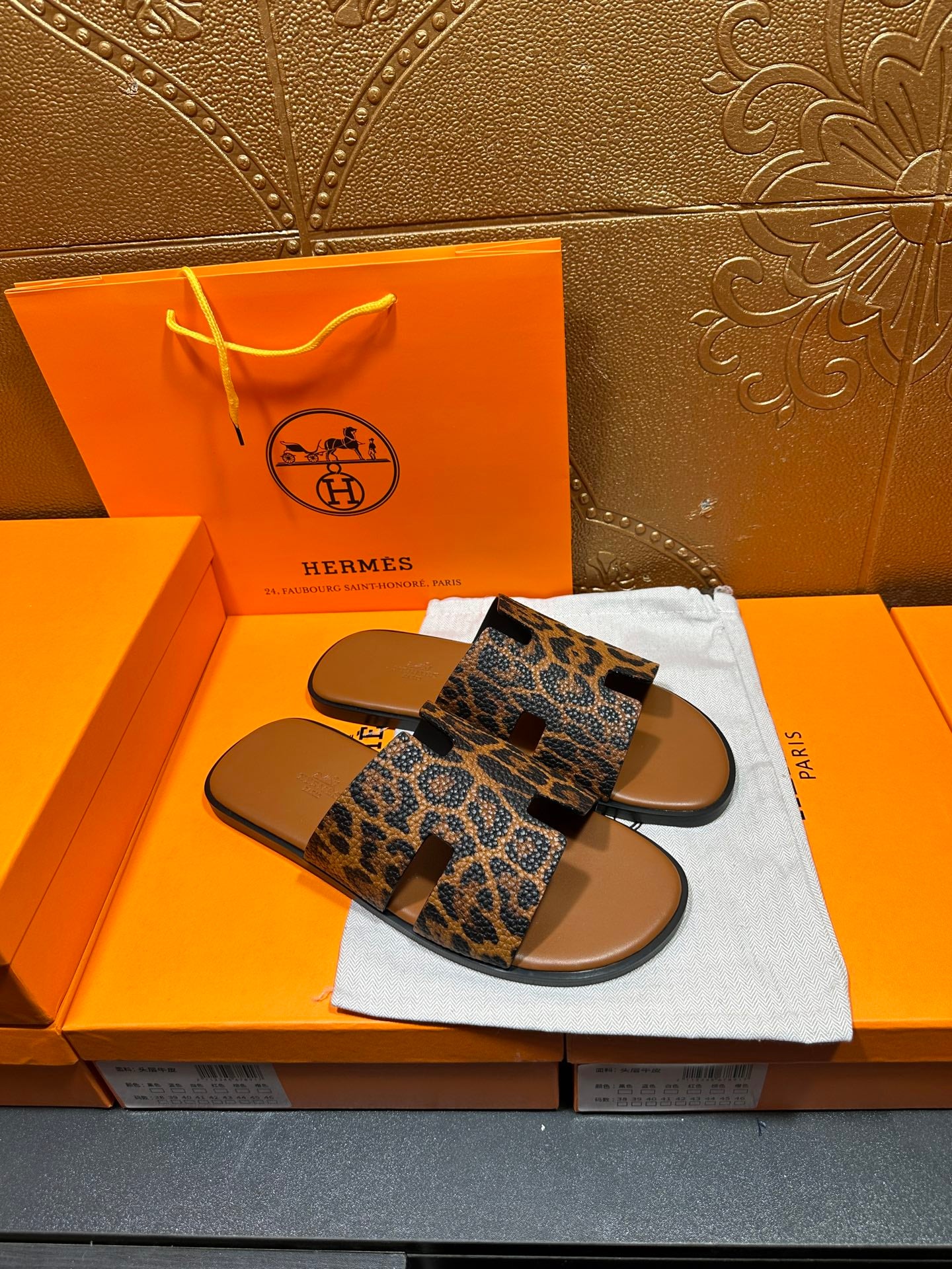Hermes leopard-print slide sandals, side view with wide straps