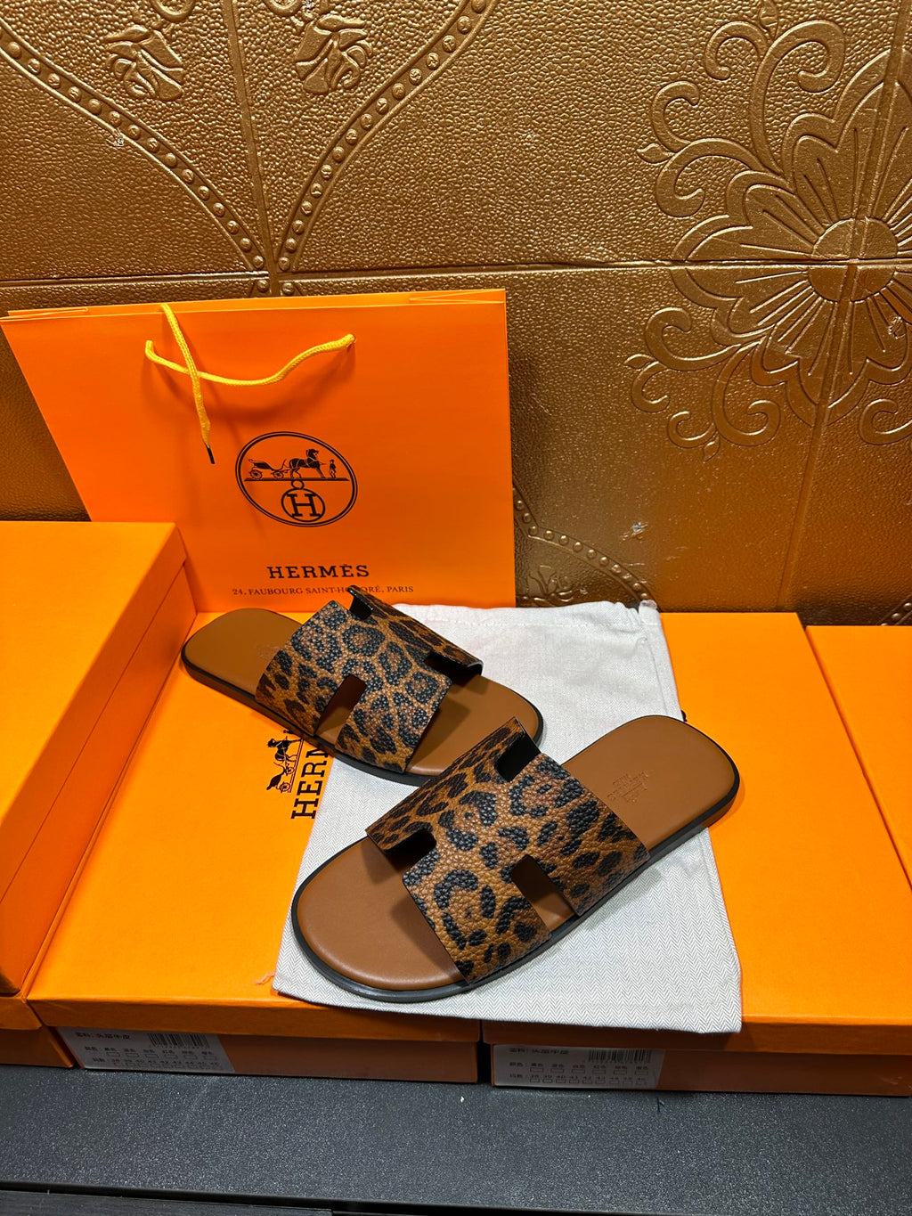 Hermes leopard-print slide sandals, top view showing wide padded straps