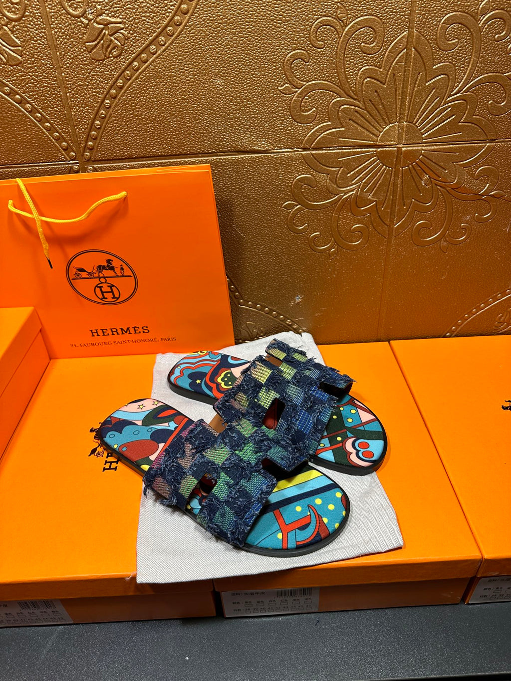 Blue and multicolor patterned slide sandals with wide textured strap and fringe