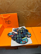 Blue and multicolor patterned slide sandals with wide textured strap and fringe