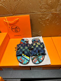 Blue patterned slide sandals with chunky toe straps and frayed ankle wrap