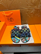 Blue patterned slide sandals with chunky toe straps and frayed ankle wrap