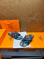 Blue patterned slide sandals with frayed ankle wrap and colorful toe-strap design