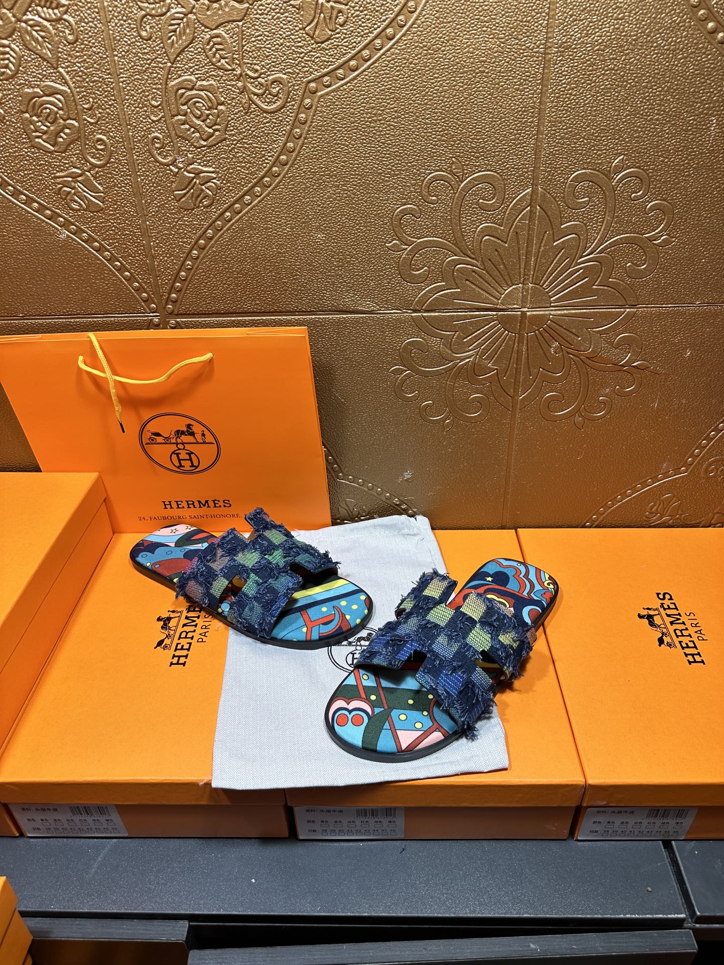 Blue patterned slide sandals with frayed ankle wrap and colorful toe-strap design
