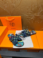 Blue patterned sandals with multicolor printed footbed and frayed ankle wrap