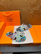 Patchwork Hermes slide sandals, front view with multicolor fabric straps and blue patterned sole