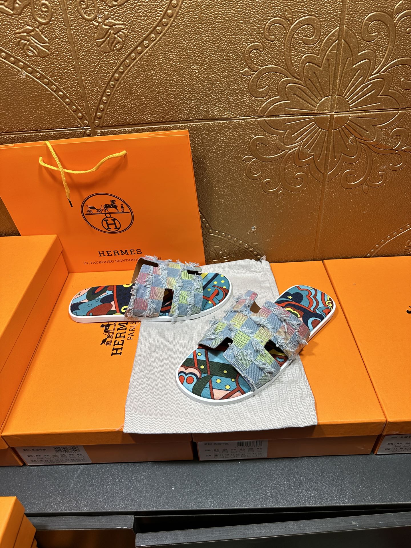 Patchwork Hermes slide sandals, laid on cloth with multicolor strap panels and graphic print