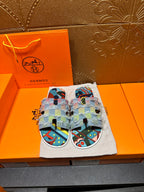 Patchwork Hermes slide sandals with fabric straps, light blue trim, colorful graphic print