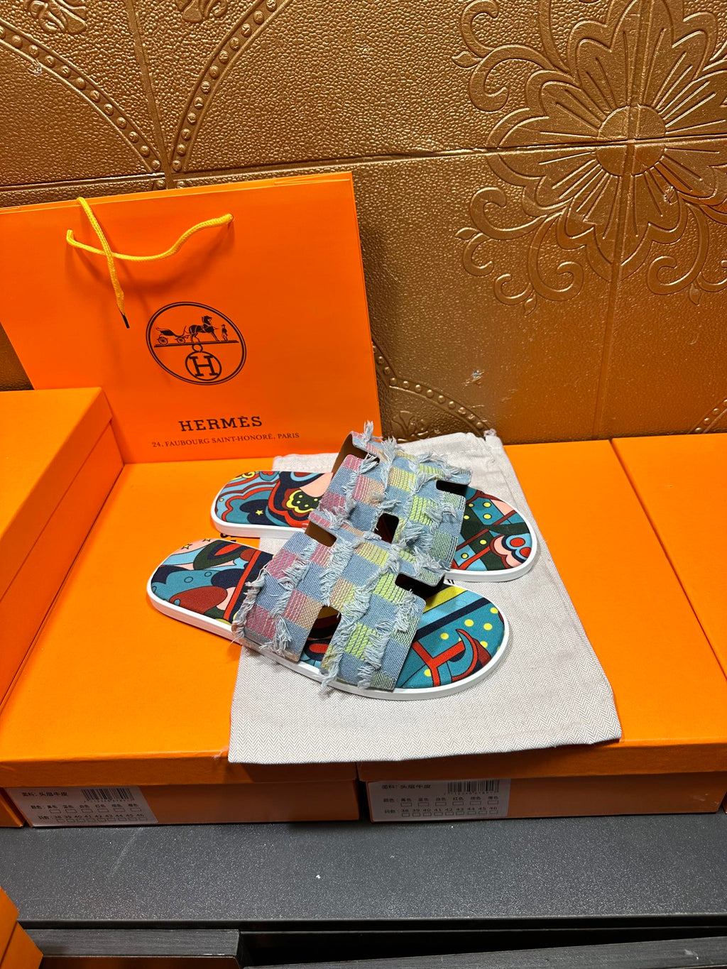 Patchwork Hermes slide sandals on pouch, multicolor fabric straps with graphic print