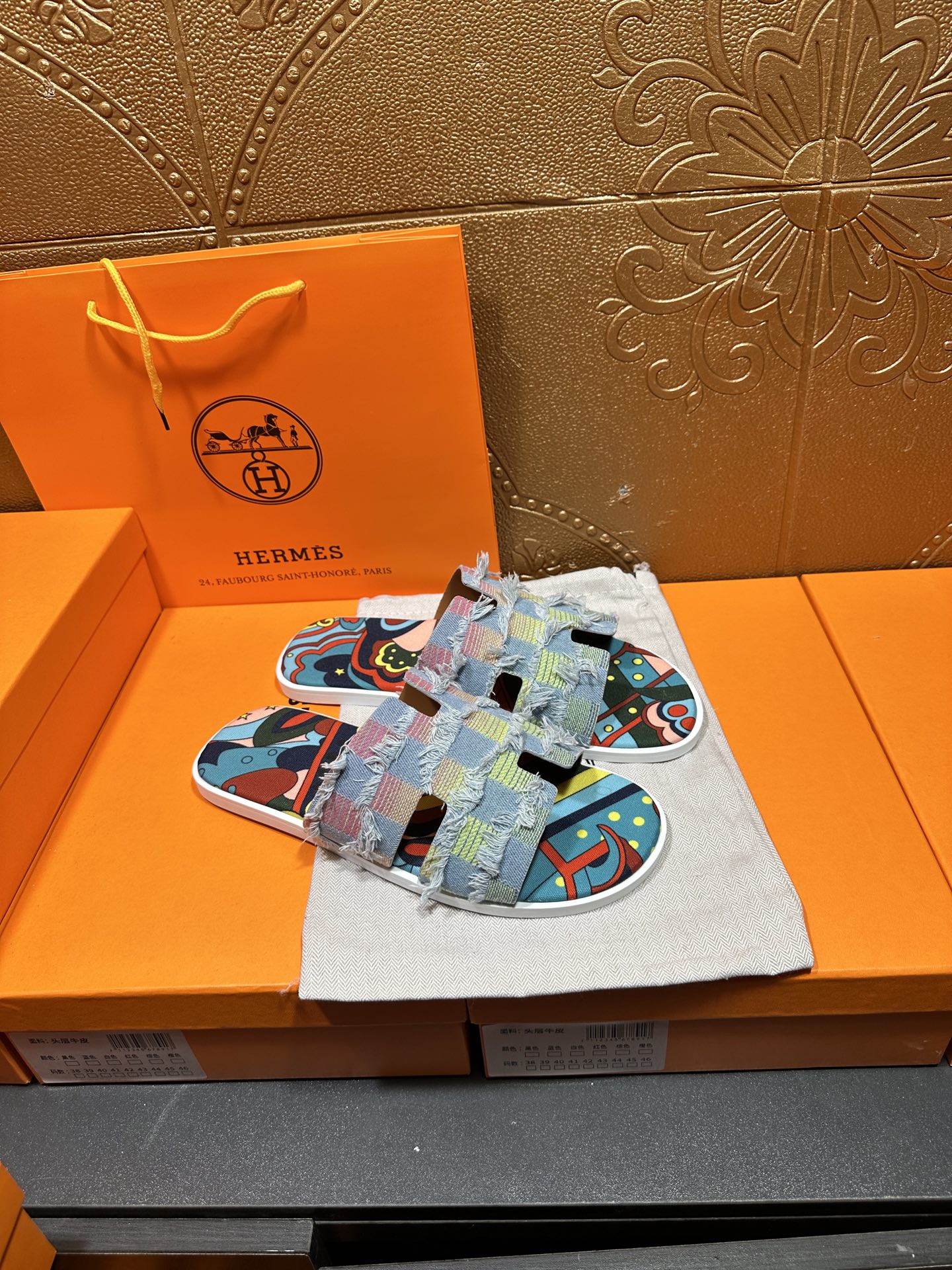 Patchwork Hermes slide sandals on pouch, multicolor fabric straps with graphic print