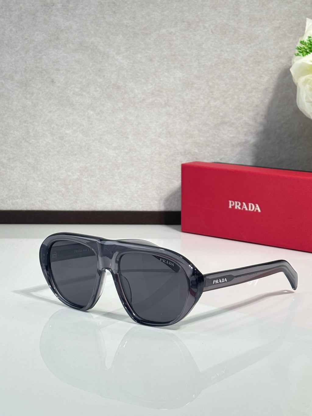 Prada oversized cat-eye sunglasses with dark blue-black frames and dark lenses