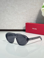 Prada oversized cat-eye sunglasses with dark blue-black frames and dark lenses
