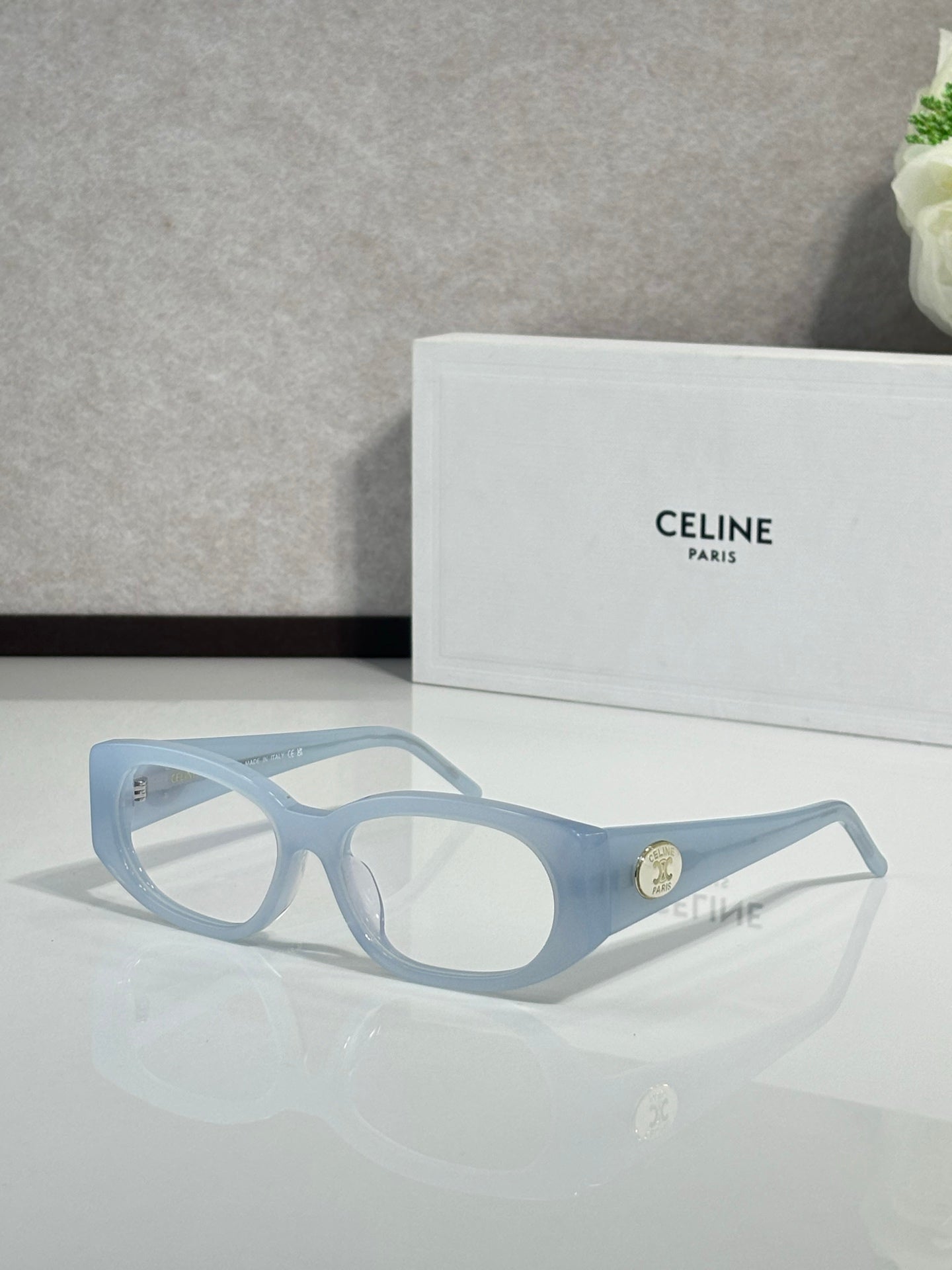 Celine oval sunglasses, light blue frame with dark lenses and gold logo detail