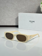 Celine oval sunglasses, cream frame with dark brown lenses and gold logo detail