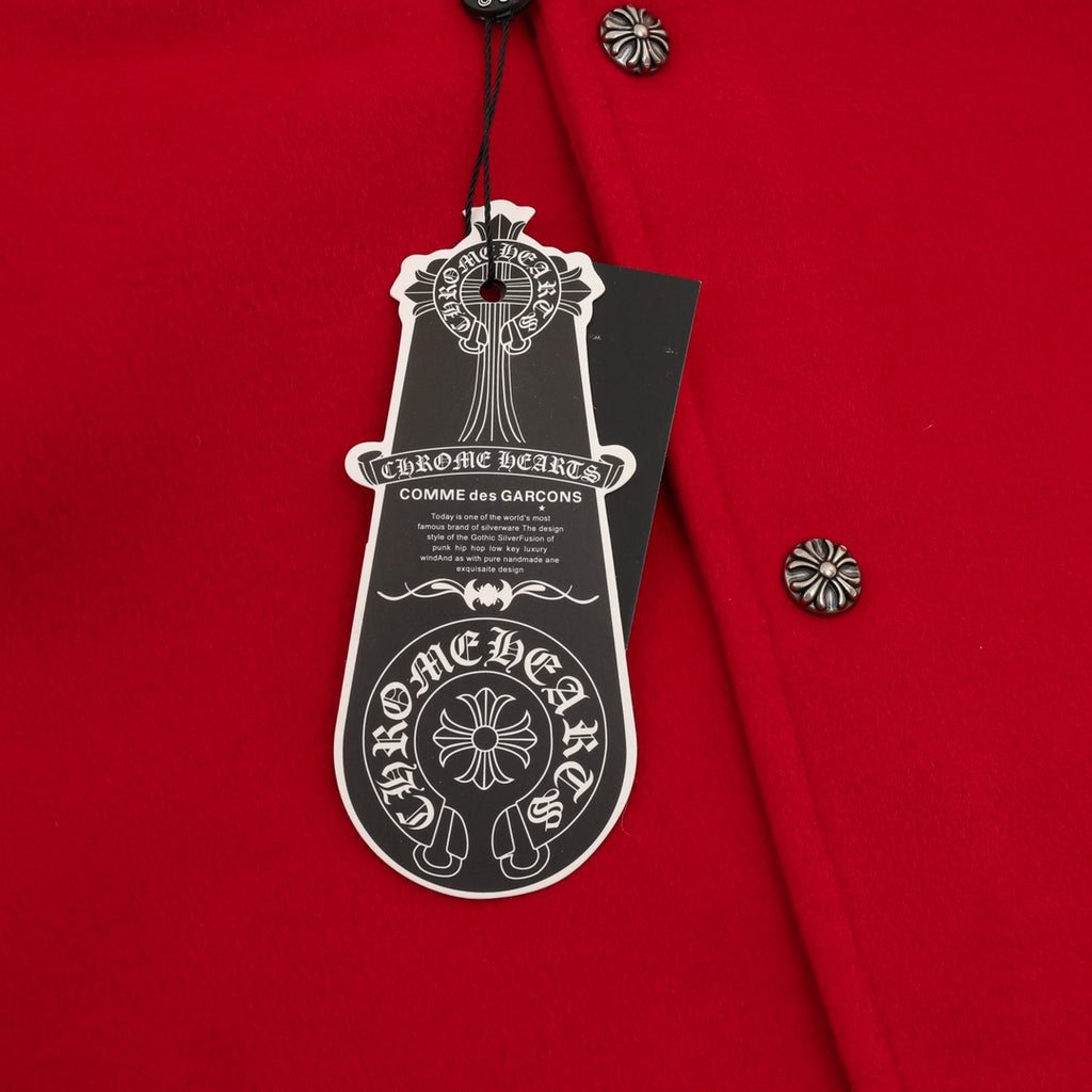 Red varsity jacket with hanging care tag and metal button details