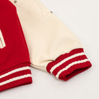 Cream sleeve with red ribbed cuff and white striped band