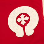 Red varsity jacket with large white logo emblem applique