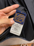 Interior neck label on dark blue puffer jacket with care text