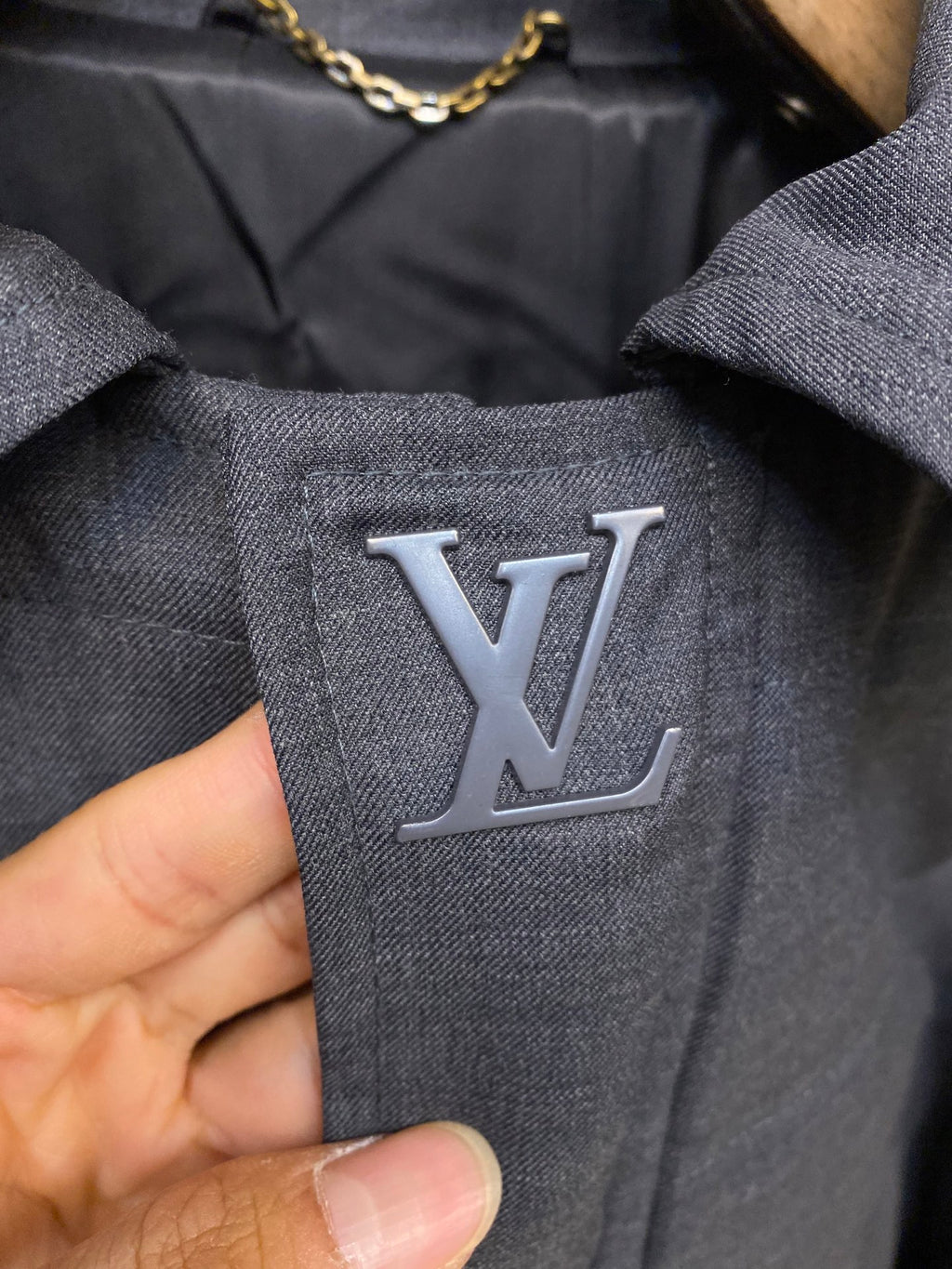 Louis Vuitton logo patch on dark blue jacket fabric