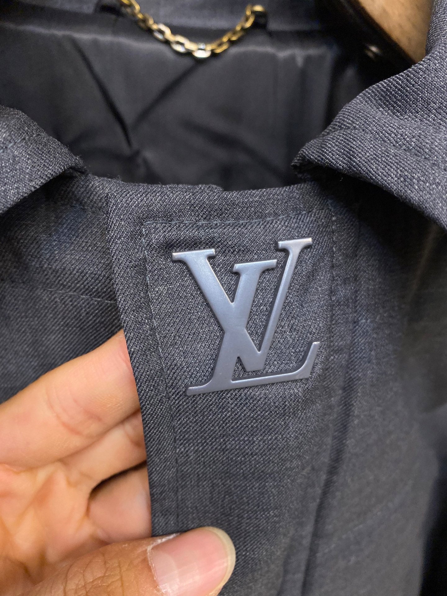 Louis Vuitton logo patch on dark blue jacket fabric
