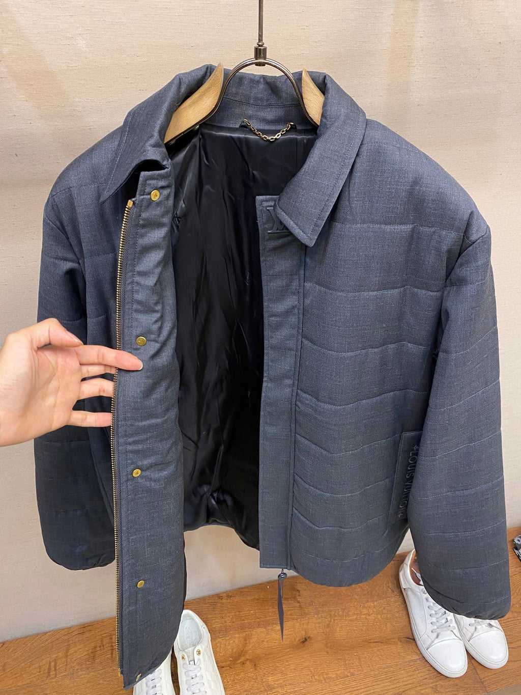 Dark blue puffer jacket open front, showing interior lining and pockets