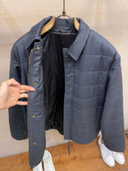 Dark blue puffer jacket open front, showing interior lining and pockets