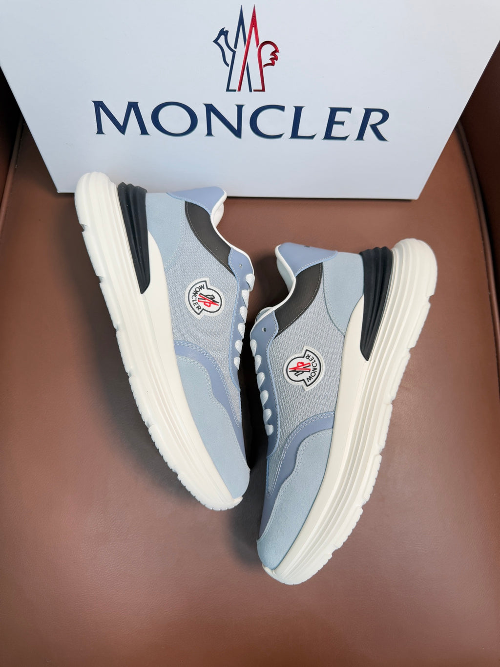 Light blue Moncler sneakers with eyelets, lace-up front, side logo patch, off-white sole