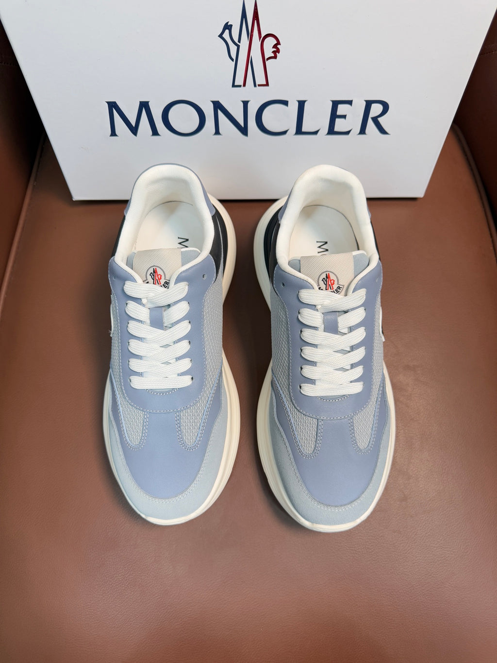 Light blue Moncler sneakers with white laces and off-white rubber sole