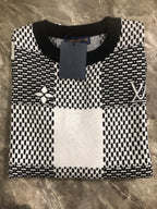 Long-sleeve sweater front with black-and-white geometric knit and Louis Vuitton label