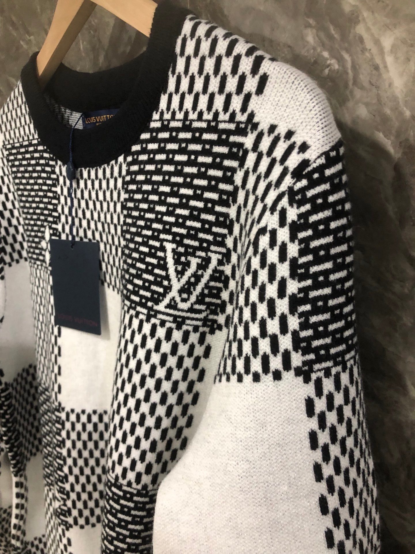 Long-sleeve sweater in black-and-white check knit, side view with hanging tag