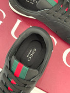 Close-up of sneaker interior collar in black with multicolor stripe at the shoe opening