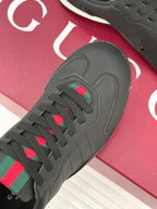 Close-up of black sneaker upper with multicolor stripe patch on the lace area