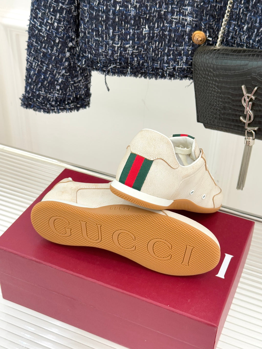 Cream Gucci sneakers rear view with gum sole, green-red web stripe on side